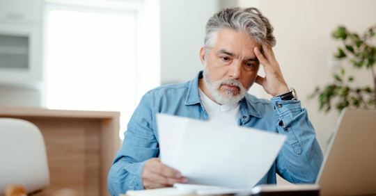 man looking at high water bill