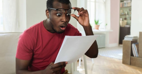 man looking at higher bill